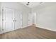 White bedroom with 2 doors and light wood flooring at 33487 Azalea Ridge Dr, Wesley Chapel, FL 33545