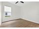 Bright bedroom with sleek ceiling fan, wood flooring and large sunny window at 33487 Azalea Ridge Dr, Wesley Chapel, FL 33545