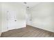 White bedroom with 2 doors and light wood flooring at 33487 Azalea Ridge Dr, Wesley Chapel, FL 33545