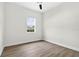 Bright bedroom with sleek ceiling fan, wood flooring and sunny window at 33487 Azalea Ridge Dr, Wesley Chapel, FL 33545