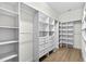 Spacious walk-in closet with custom shelves, drawers, and wood floors for ample storage at 33487 Azalea Ridge Dr, Wesley Chapel, FL 33545