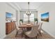 Elegant dining room featuring a tray ceiling, modern light fixture, and stylish decor at 33487 Azalea Ridge Dr, Wesley Chapel, FL 33545