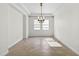 Bright, airy room with tray ceiling, modern light fixture, and neutral flooring at 33487 Azalea Ridge Dr, Wesley Chapel, FL 33545