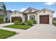 Charming home featuring a two-car garage, well-manicured landscaping, and a welcoming facade at 33487 Azalea Ridge Dr, Wesley Chapel, FL 33545