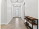 Well-lit hallway featuring arched doorways, recessed lighting, and a console table at 33487 Azalea Ridge Dr, Wesley Chapel, FL 33545