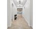 Bright and airy hallway with elegant archways, decorative lighting, and neutral tile flooring at 33487 Azalea Ridge Dr, Wesley Chapel, FL 33545