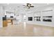 The open floor plan features a large kitchen island with seating and stainless appliances in the background at 33487 Azalea Ridge Dr, Wesley Chapel, FL 33545