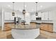 Spacious kitchen boasts a large island, granite countertops, stainless steel appliances, and stylish pendant lighting at 33487 Azalea Ridge Dr, Wesley Chapel, FL 33545