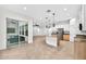 Open floor plan features a large kitchen with an island and stainless appliances next to sliding glass doors at 33487 Azalea Ridge Dr, Wesley Chapel, FL 33545