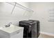 Functional laundry room area with modern washer and dryer hookups and utility sink at 33487 Azalea Ridge Dr, Wesley Chapel, FL 33545