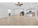 Bright living space boasts an open floor plan with tile flooring extending into the kitchen at 33487 Azalea Ridge Dr, Wesley Chapel, FL 33545