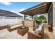 Inviting outdoor living space with a seating area, bar, and dining table, perfect for entertaining at 33487 Azalea Ridge Dr, Wesley Chapel, FL 33545