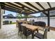 Outdoor patio area with a built-in grill, dining table, pergola with fan, great for entertaining at 33487 Azalea Ridge Dr, Wesley Chapel, FL 33545