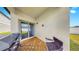 Back porch with tile flooring, a grill, and an outdoor chair at 35552 Shade Fern Ln, Zephyrhills, FL 33541