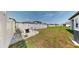 Spacious backyard with well-maintained lawn, white fence, and outdoor seating area at 35552 Shade Fern Ln, Zephyrhills, FL 33541