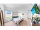 Spacious bedroom with carpet flooring and a beach scene displayed on the mounted television at 35552 Shade Fern Ln, Zephyrhills, FL 33541
