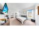 Bright bedroom featuring carpet flooring, a ceiling fan, and a decorative TV at 35552 Shade Fern Ln, Zephyrhills, FL 33541