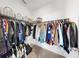 Walk-in closet with wire shelving and an extensive hanging wardrobe at 35552 Shade Fern Ln, Zephyrhills, FL 33541
