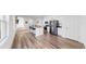 Open-concept kitchen with island, stainless steel appliances, seamlessly flowing into living spaces at 35552 Shade Fern Ln, Zephyrhills, FL 33541
