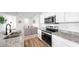 Bright kitchen features stainless steel appliances, granite countertops and a modern design at 35552 Shade Fern Ln, Zephyrhills, FL 33541