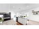 Eat-in kitchen island featuring white cabinetry, seating, and stainless steel appliances at 35552 Shade Fern Ln, Zephyrhills, FL 33541