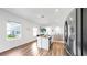 Modern kitchen with an island, stainless steel appliances, and wood-look flooring at 35552 Shade Fern Ln, Zephyrhills, FL 33541