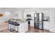 Open kitchen with an island, granite countertops, stainless steel appliances, and bar stool seating at 35552 Shade Fern Ln, Zephyrhills, FL 33541