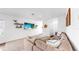 Spacious living room with plush seating, floating shelves, and a mounted television at 35552 Shade Fern Ln, Zephyrhills, FL 33541