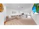 Open-concept living space with modern furnishings and seamless flow to the kitchen at 35552 Shade Fern Ln, Zephyrhills, FL 33541