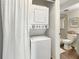 Bright, tiled bathroom featuring stackable washer/dryer and modern finishes, creating a convenient and stylish space at 366 47Th N Ave # 3, St Petersburg, FL 33703