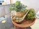 Dining table centerpiece featuring decorative plants, artichokes and a golden bird at 366 47Th N Ave # 3, St Petersburg, FL 33703