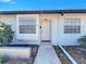 Inviting front entrance of a well-maintained townhome with a charming walkway and neat landscaping at 366 47Th N Ave # 3, St Petersburg, FL 33703