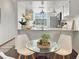 View of the kitchen from the dining area, showcasing a functional space with modern appliances and bright lighting at 366 47Th N Ave # 3, St Petersburg, FL 33703