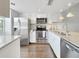 Updated kitchen with stainless steel appliances, granite countertops, and white cabinetry for a modern aesthetic at 366 47Th N Ave # 3, St Petersburg, FL 33703