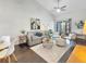 Bright living room featuring vaulted ceilings, stylish furnishings, and sliding doors to outdoor space at 366 47Th N Ave # 3, St Petersburg, FL 33703