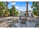 Backyard oasis with lush landscaping, a fire pit, and comfortable seating at 3800 Shore Acres Ne Blvd, St Petersburg, FL 33703