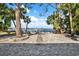 Serene backyard featuring waterfront views with a stone pathway and lush landscaping at 3800 Shore Acres Ne Blvd, St Petersburg, FL 33703