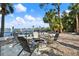 Inviting backyard space with a fire pit, seating area, and water views at 3800 Shore Acres Ne Blvd, St Petersburg, FL 33703