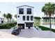 Three-story coastal home with modern design, manicured lawn, and stunning water view at 3800 Shore Acres Ne Blvd, St Petersburg, FL 33703
