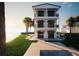 Beautiful three-story waterfront home boasts balconies on each level and a refreshing pool surrounded by lush landscaping at 3800 Shore Acres Ne Blvd, St Petersburg, FL 33703