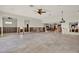 Open living area featuring tile floors, ceiling fans, and open access to fireplace at 3800 Shore Acres Ne Blvd, St Petersburg, FL 33703