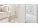 Bathroom showcasing glass-enclosed shower, white cabinets, and view into bedroom at 448 31St N Ln, St Petersburg, FL 33713