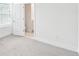 Bright bedroom featuring plush carpet, a window with blinds, and an ensuite bathroom at 448 31St N Ln, St Petersburg, FL 33713