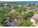 Aerial perspective of a property outlined in red, nestled among lush greenery and neighboring houses near the waterfront at 4711 W Vasconia St, Tampa, FL 33629