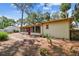 Picture of home showcasing the backyard with a sunroom, patio, and landscaping, offering a peaceful retreat at 4711 W Vasconia St, Tampa, FL 33629