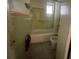 Bathroom area with a toilet, shower/bath, and a window at 4711 W Vasconia St, Tampa, FL 33629