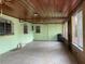 Enclosed patio area with multiple windows and a door at 4711 W Vasconia St, Tampa, FL 33629