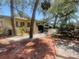 Side exterior with brick pathway showing landscaping and access to the backyard at 4711 W Vasconia St, Tampa, FL 33629