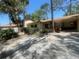 Exterior view of home featuring a well-maintained lawn, brick accents, and mature trees at 4711 W Vasconia St, Tampa, FL 33629
