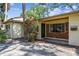 Home's welcoming front porch features brick accents, adding curb appeal and leading to the main entrance at 4711 W Vasconia St, Tampa, FL 33629